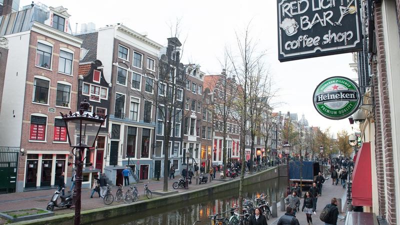 Amsterdam red light district during day street view bars